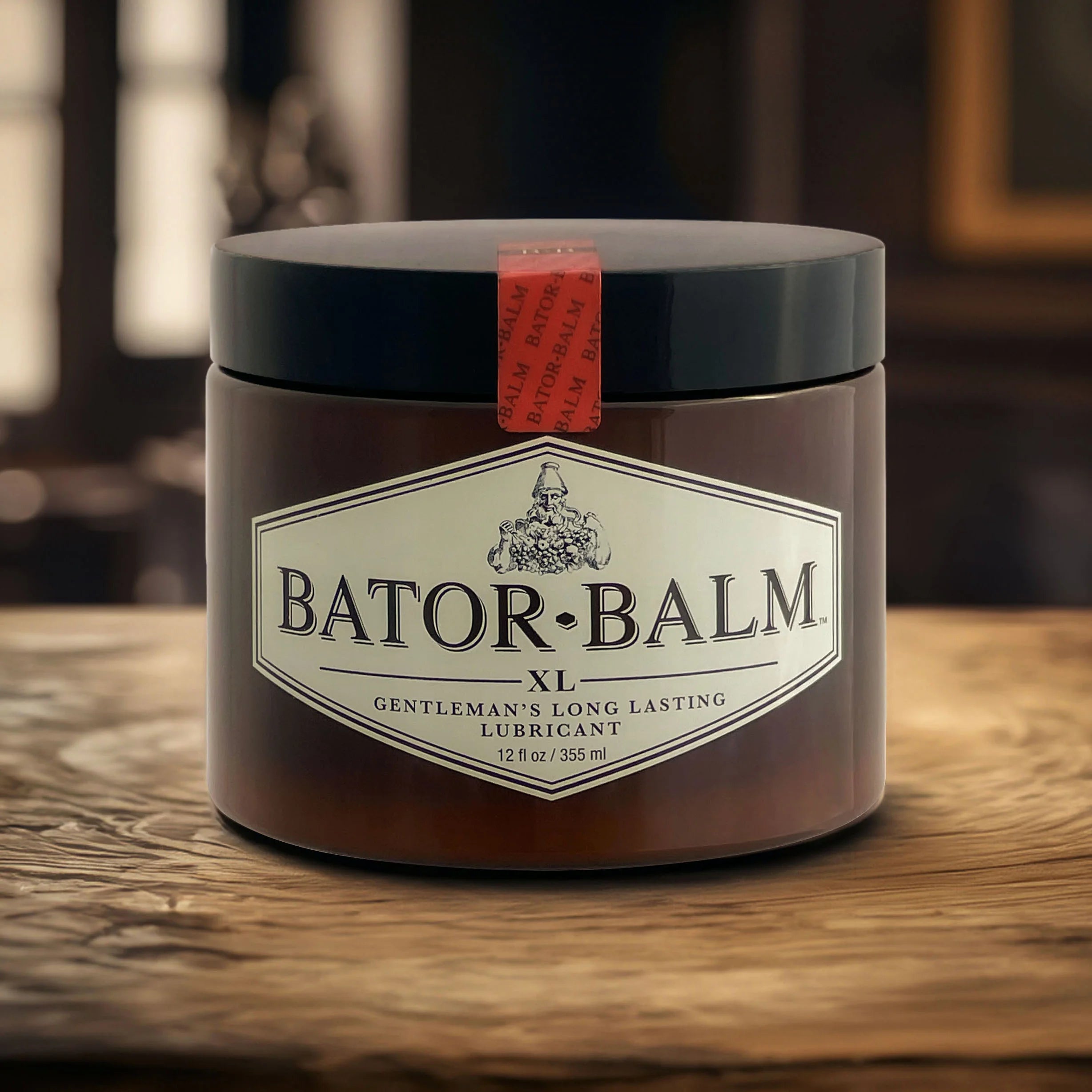 Jar of Bator Balm on a wooden surface with a blurred background