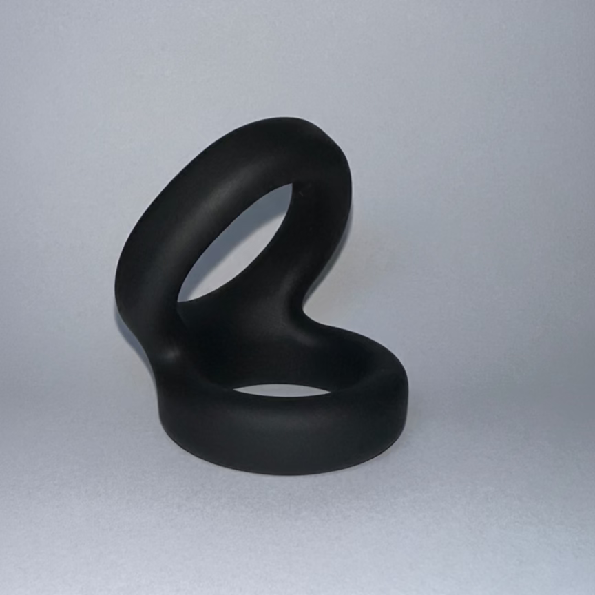 Black silicone penis ring on a white background