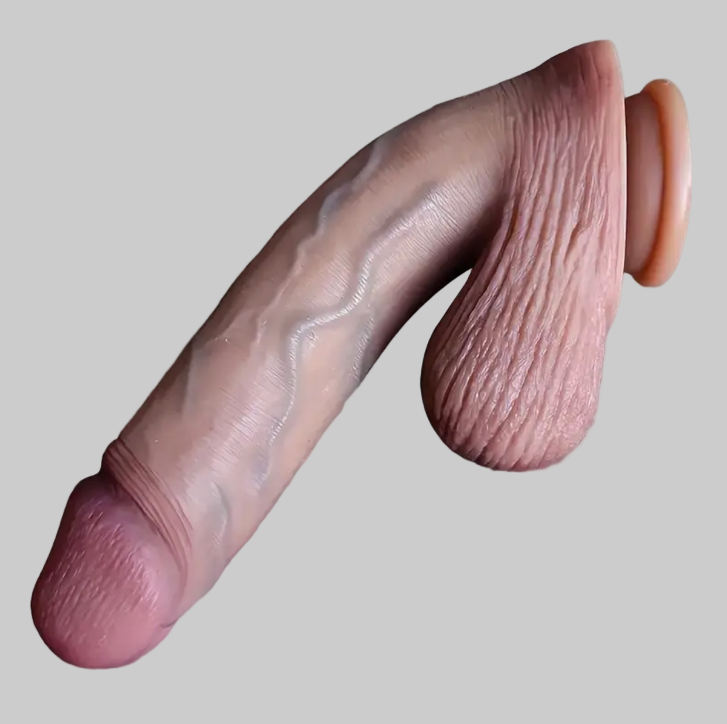 Realistic silicone dildo on a gray background