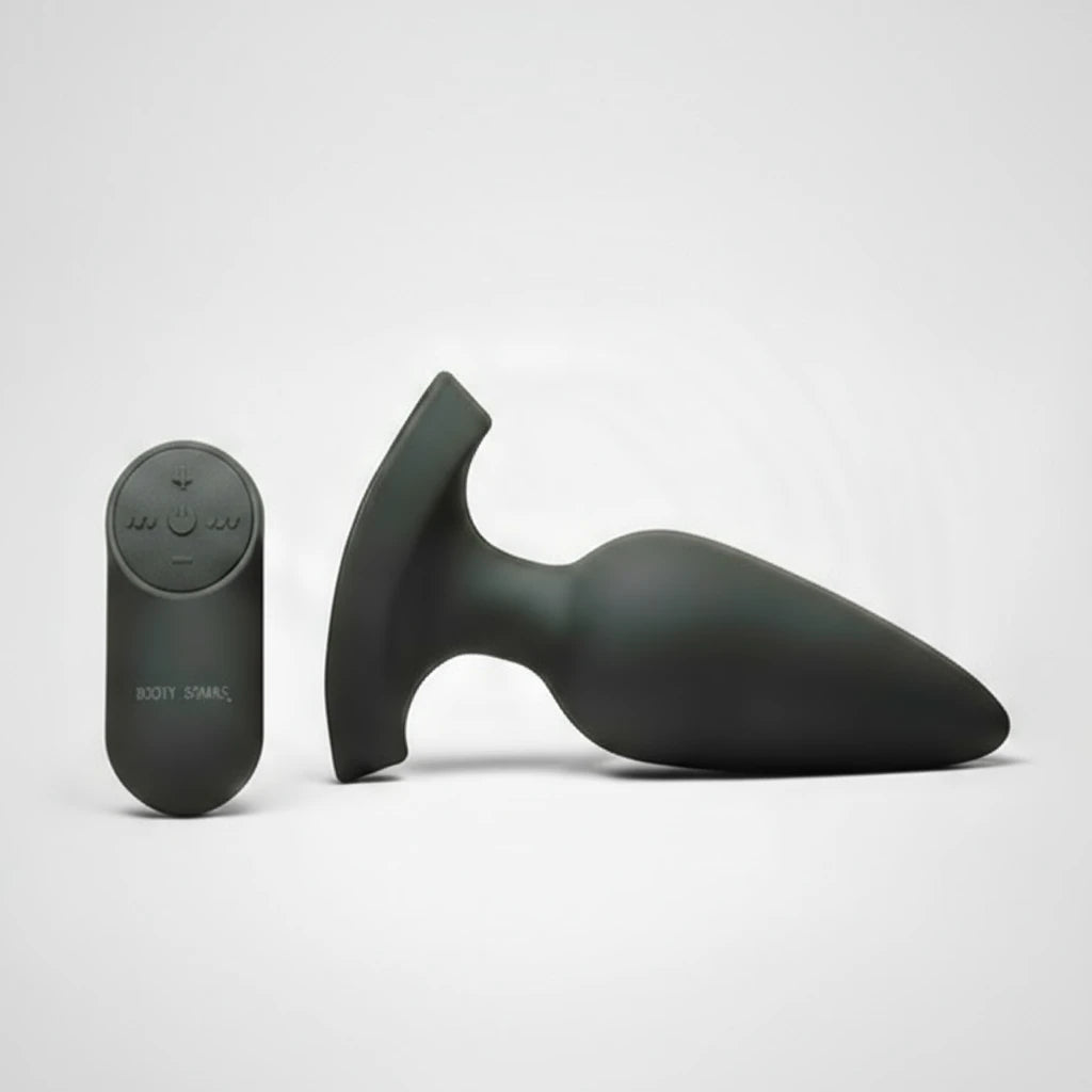 Black silicone butt plug and remote control on a white background